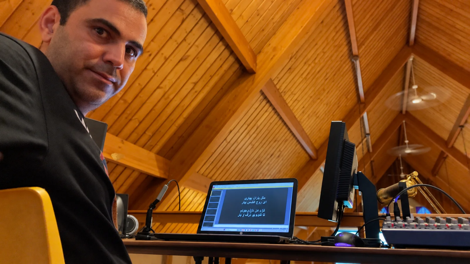 At the church audiovisual workstation with projection laptop and audio equipment