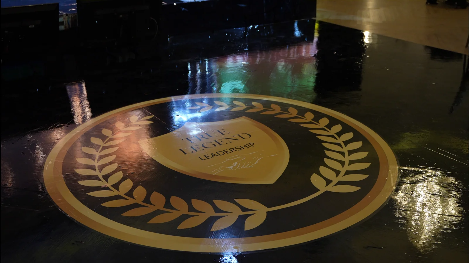 TRUE LEGEND emblem on the event stage floor